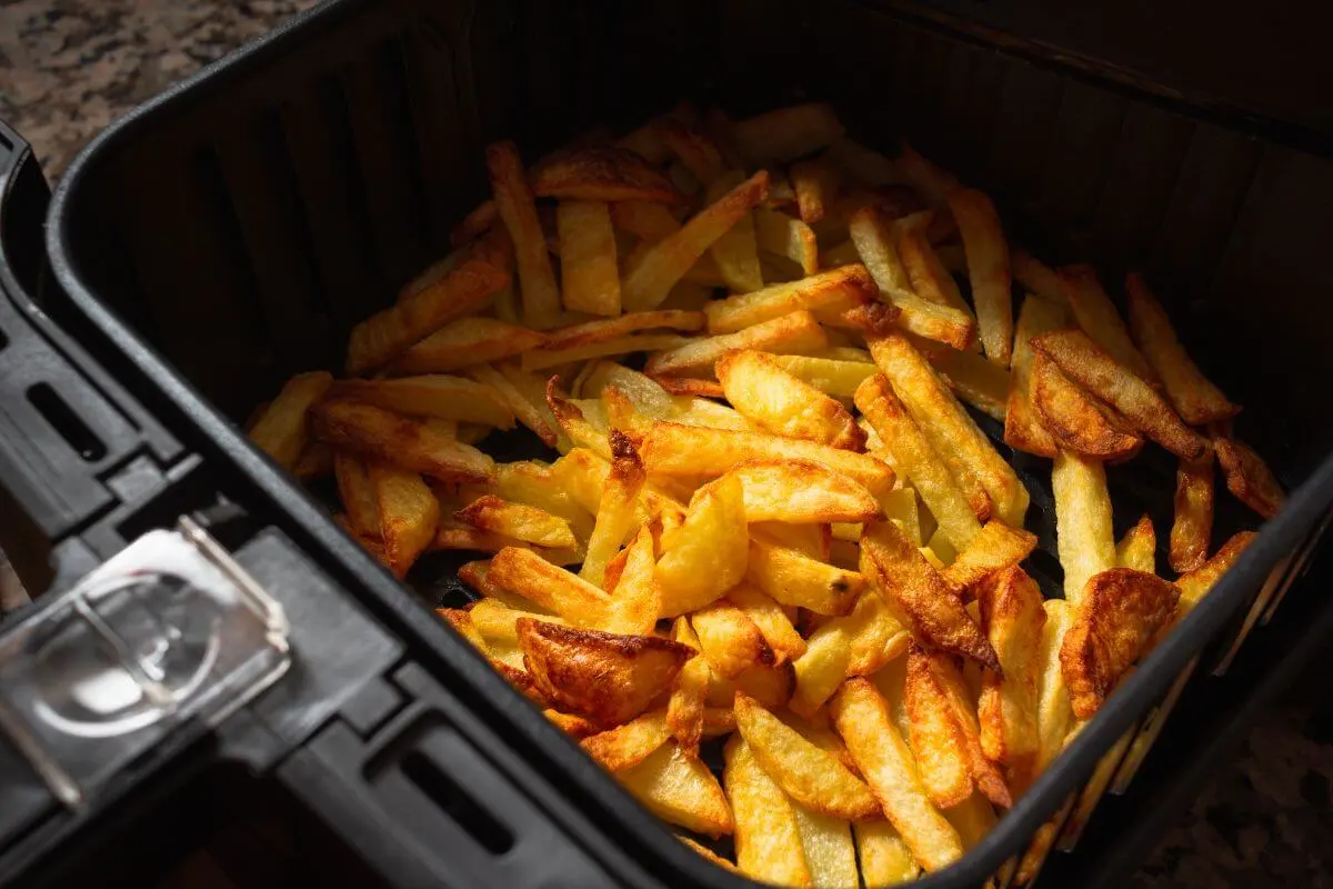 Golden crispy French fries in an air fryer basket