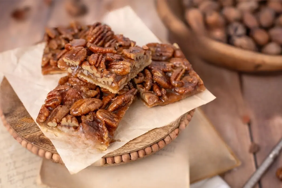 pecan crackers on parchment and wooden plate