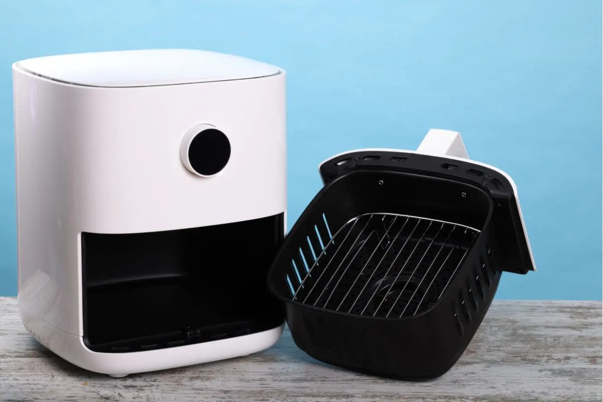 Clean and empty air fryer after Cooking cooking frozen hash brown patties.