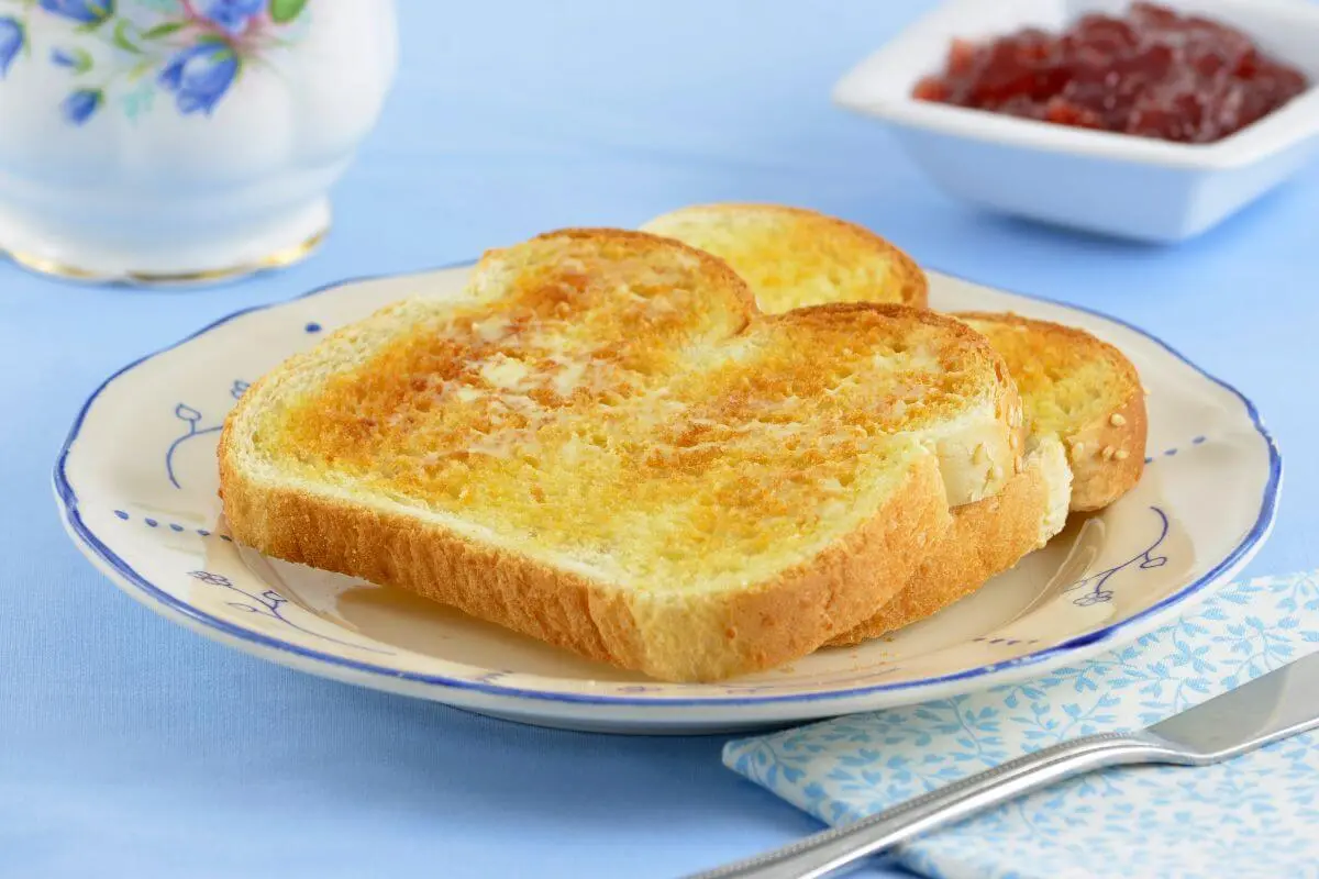 Golden toasted slices of two-ingredient cottage cheese bread on a decorative plate.