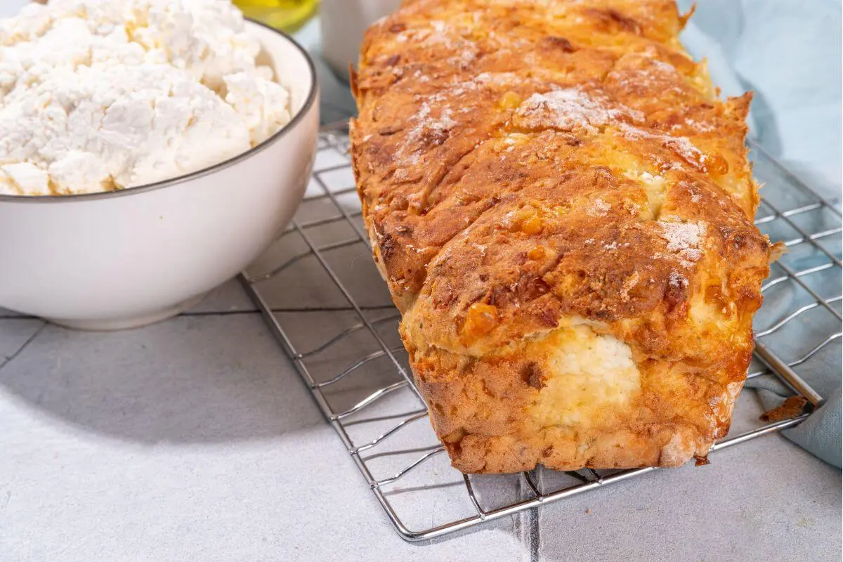 Homemade two-ingredient cottage cheese bread on a wire cooling rack.