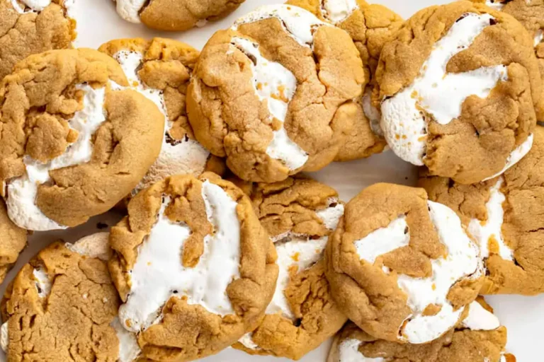 Fluffernutter cookies with marshmallow filling on parchment paper