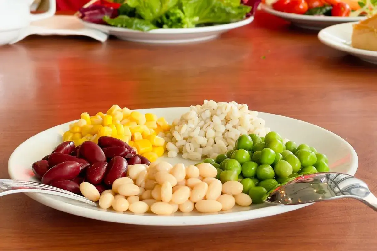 Assorted beans and vegetables neatly arranged on a plate