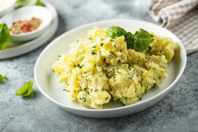 Southern-style potato salad garnished with fresh herbs