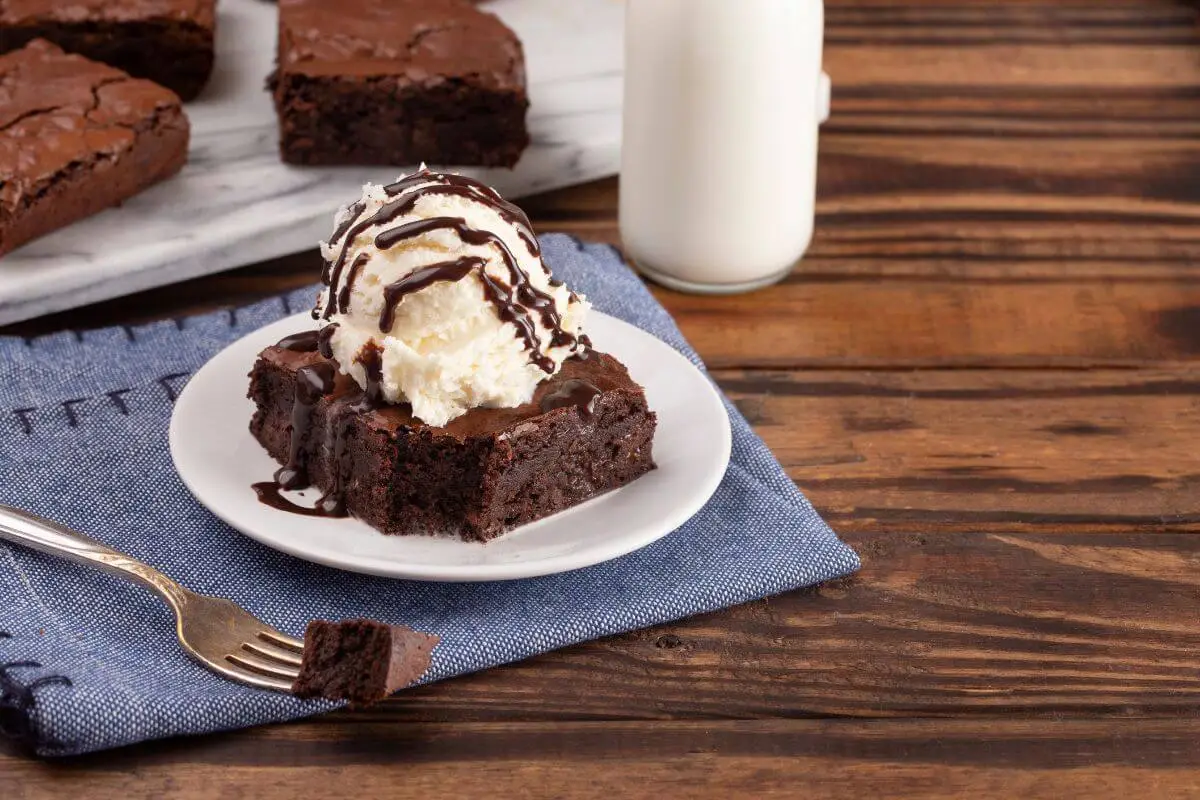 Gooey chocolate brownie sundae with vanilla ice cream and chocolate syrup.