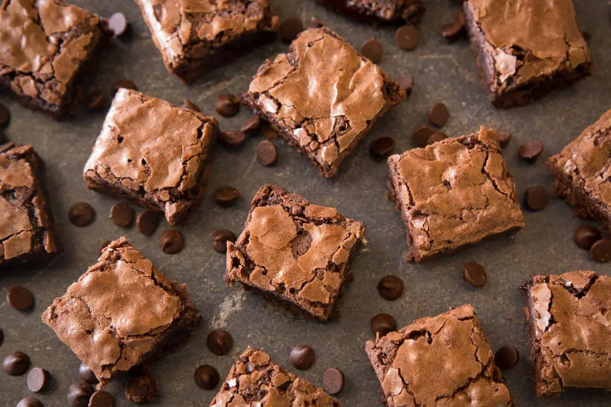 Chewy chocolate brownies with cracked tops and scattered chocolate chips.